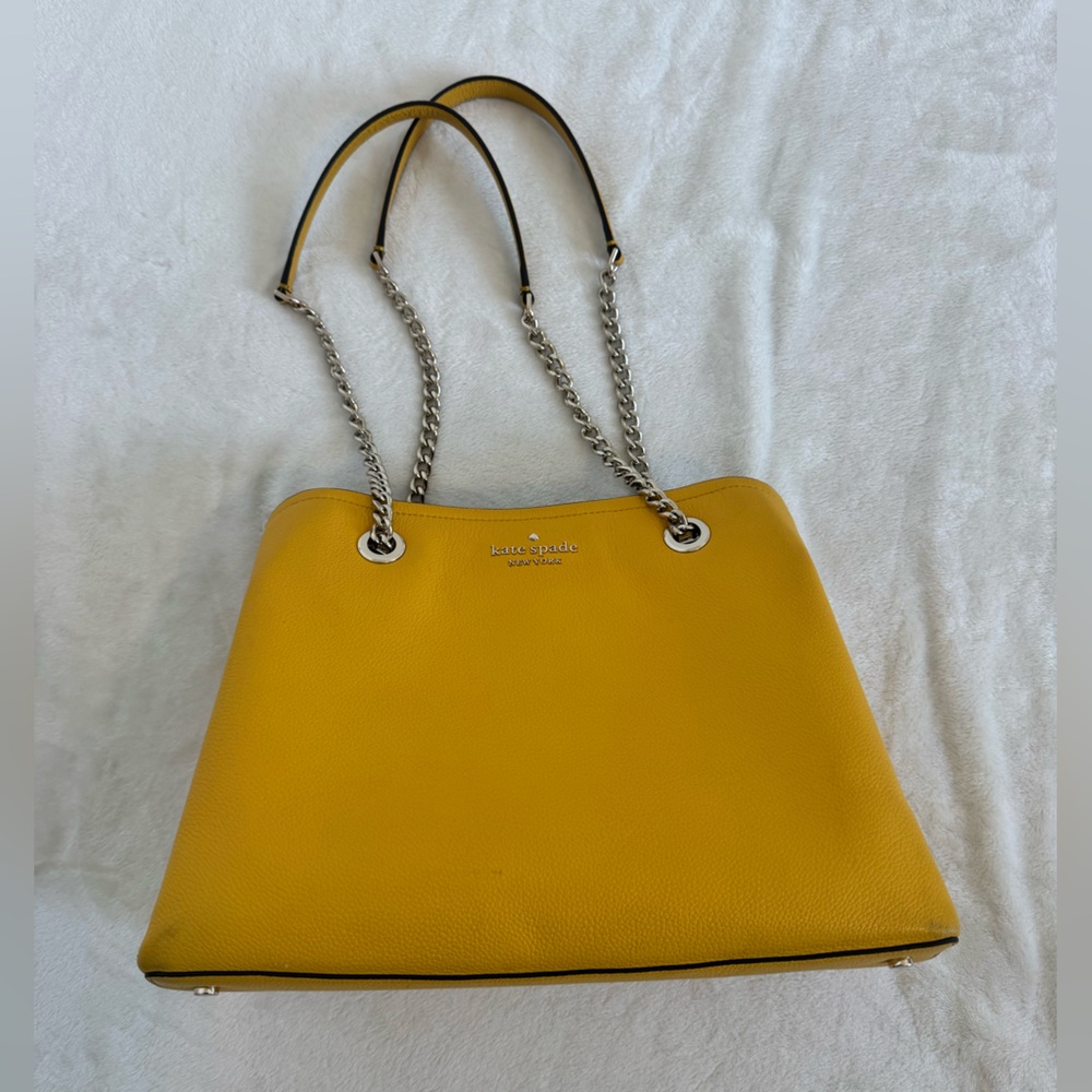 kate spade mustard yellow shoulder bag w/ silver accents. Center zipper section